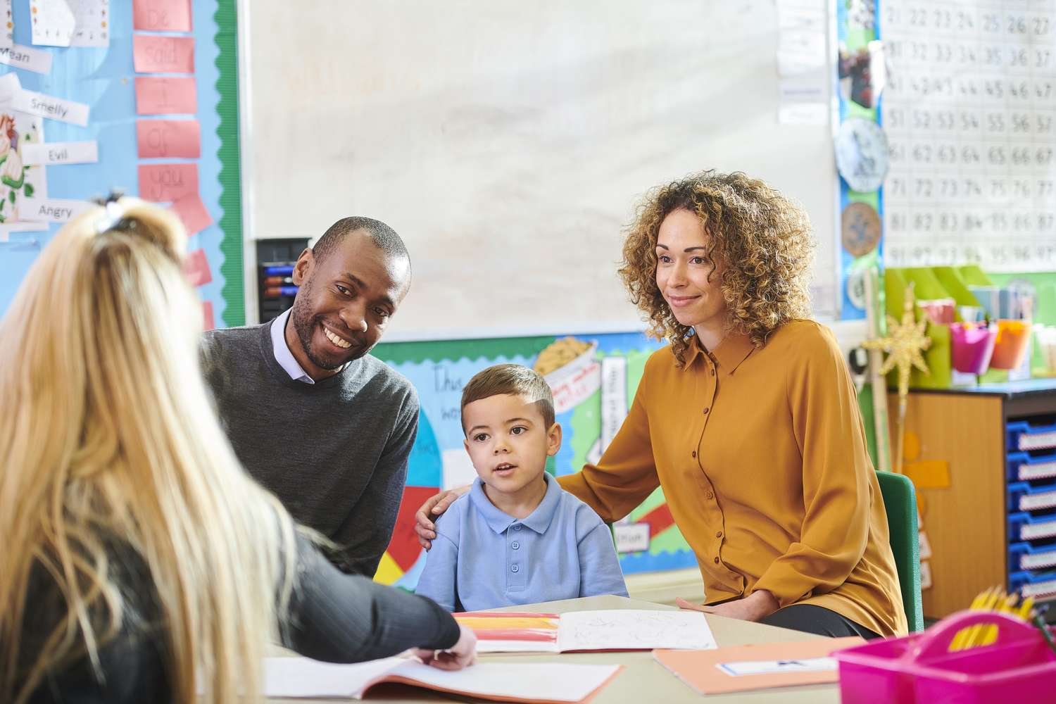 EIBP teacher meeting with parents and their child during an admissions conversation